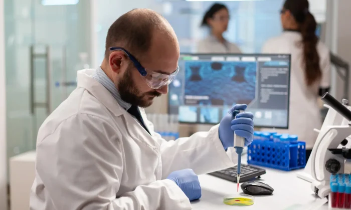 imgi_4_biochemistry-health-care-scientist-testing-blood-sample-using-micropipette